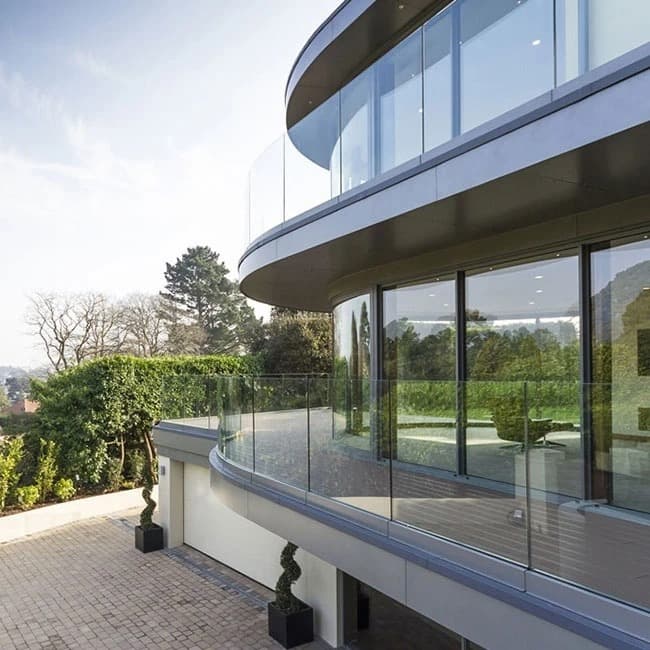 Waterfront home with frameless glass railings on the terraces